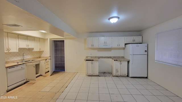 kitchen featuring sink, light tile patterned floors, white appliances, decorative backsplash, and white cabinets