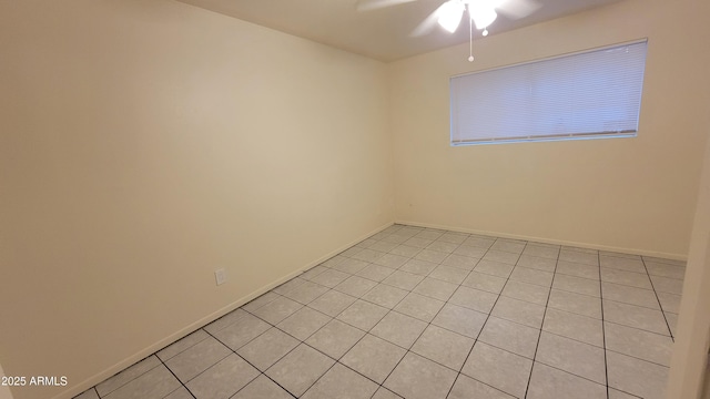 spare room featuring ceiling fan and light tile patterned floors