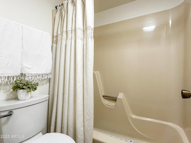 bathroom with shower / bath combo and toilet