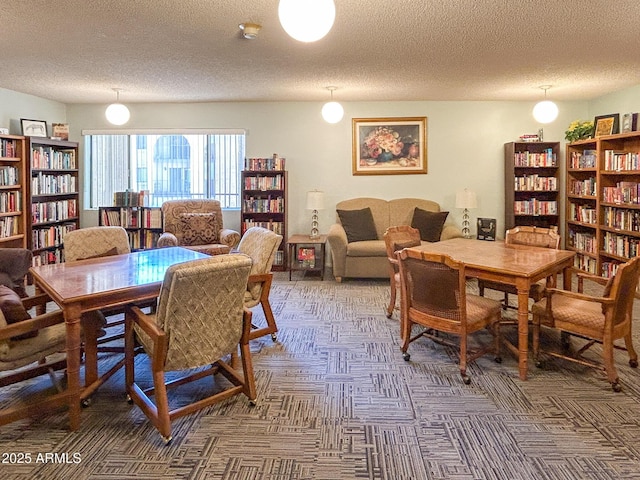 carpeted dining area with a textured ceiling