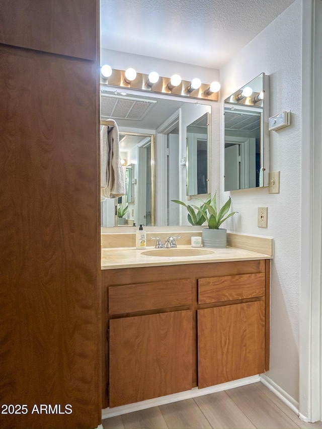 bathroom with vanity and a textured ceiling