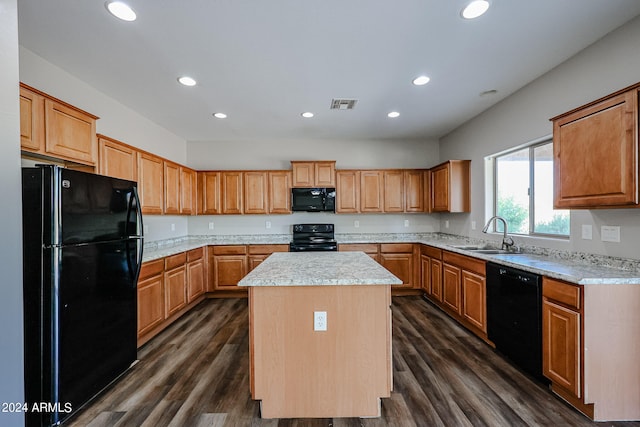 kitchen with black appliances, dark wood-type flooring, sink, and a kitchen island