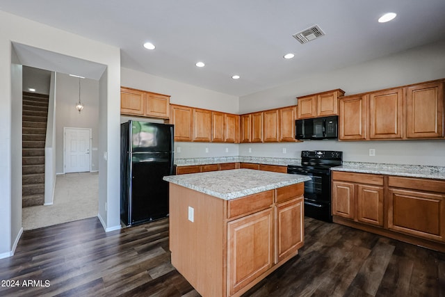 kitchen with black appliances, light stone counters, dark wood-type flooring, and a kitchen island