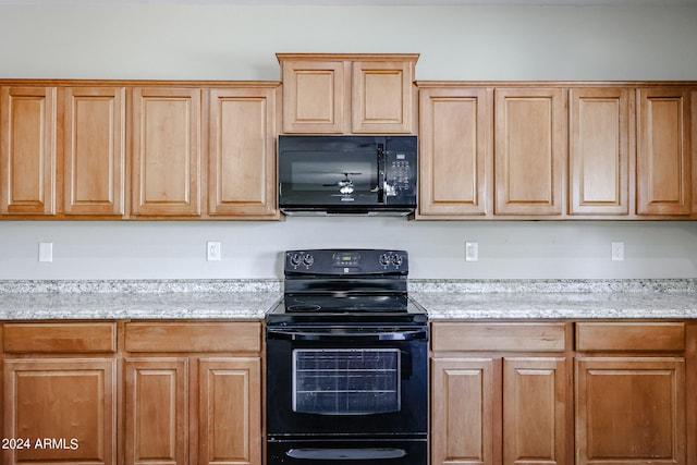 kitchen featuring black appliances and light stone countertops