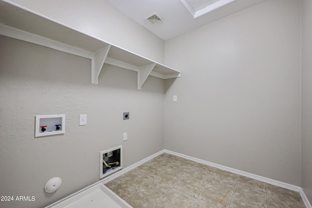 clothes washing area featuring hookup for a washing machine, light tile patterned flooring, gas dryer hookup, and hookup for an electric dryer