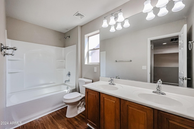 full bathroom with vanity, toilet, hardwood / wood-style floors, and shower / bath combination