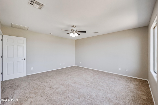 spare room featuring carpet flooring and ceiling fan