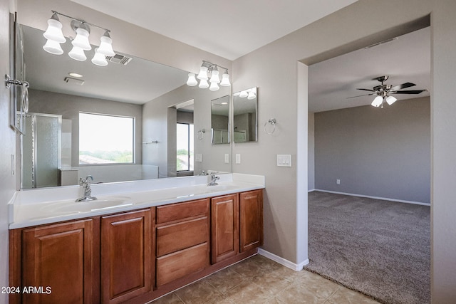 bathroom with tile patterned flooring, vanity, ceiling fan, and an enclosed shower