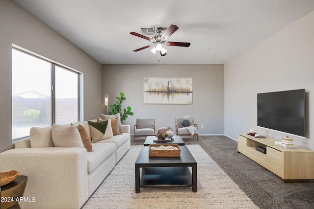 carpeted living room with ceiling fan