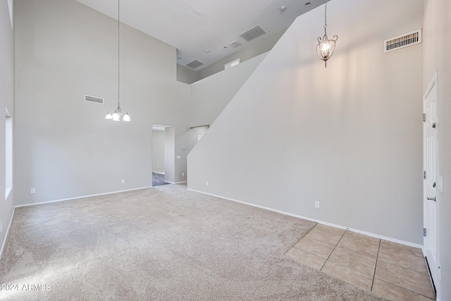 interior space featuring an inviting chandelier and high vaulted ceiling