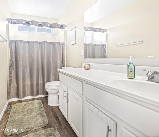 bathroom with toilet, vanity, a shower with shower curtain, and hardwood / wood-style floors