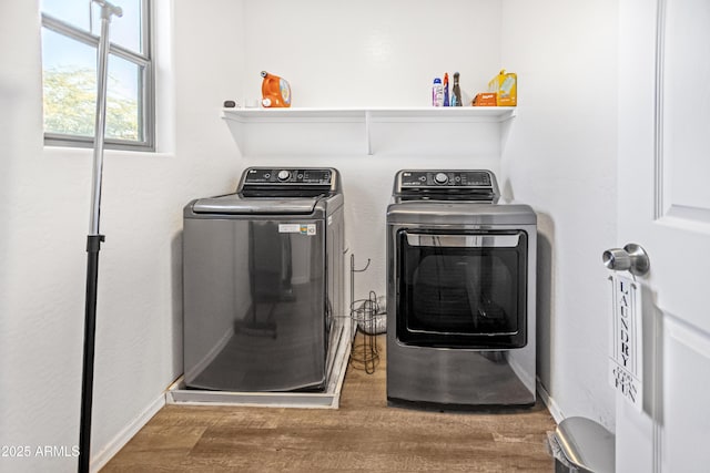 clothes washing area featuring dark hardwood / wood-style floors and washer and dryer