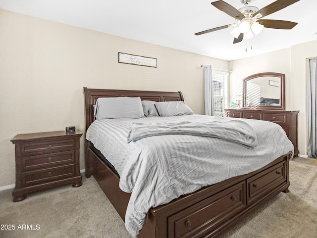 bedroom with ceiling fan and light colored carpet