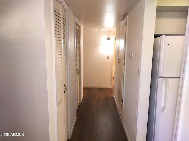 hall with dark wood-type flooring