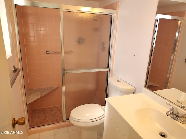 bathroom featuring vanity, tile patterned flooring, a shower with shower door, and toilet