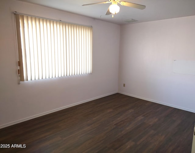 empty room with dark hardwood / wood-style floors and ceiling fan