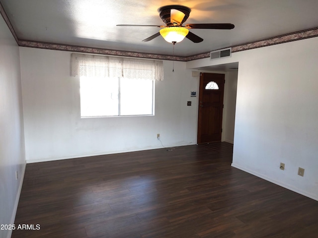 empty room featuring ceiling fan and dark hardwood / wood-style flooring