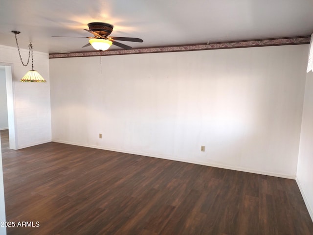 empty room featuring ceiling fan and dark hardwood / wood-style flooring