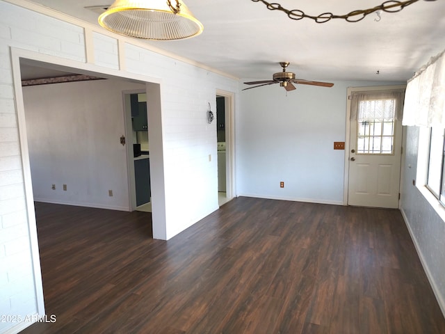 spare room with dark hardwood / wood-style flooring and ceiling fan