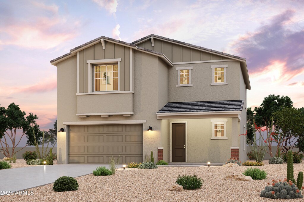 view of front of house with a garage, concrete driveway, board and batten siding, and stucco siding