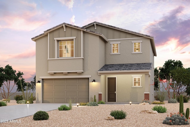 view of front of house with a garage, concrete driveway, board and batten siding, and stucco siding