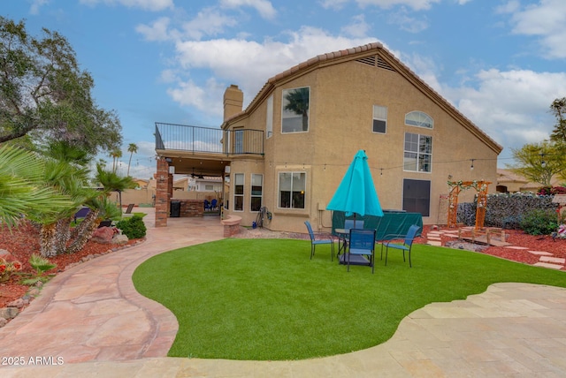 5940 W Robinson Way, Chandler, AZ 85226 - rear view of property with a balcony, a patio area, a chimney, a yard, and stucco siding