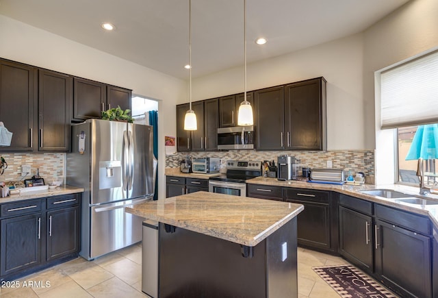 5940 W Robinson Way, Chandler, AZ 85226 - kitchen with stainless steel appliances, a sink, tasteful backsplash, light tile patterned floors, and light stone counters