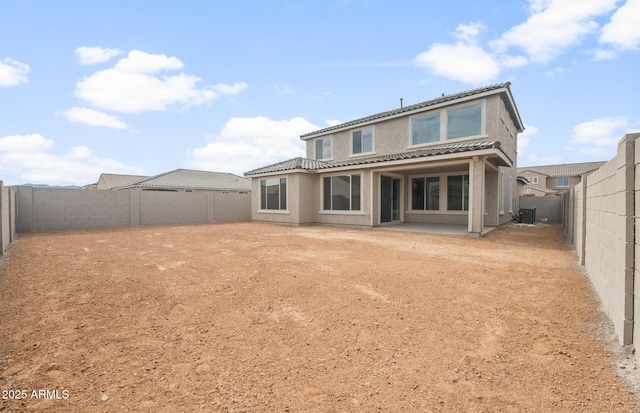17633 W Palo Verde Dr, Litchfield Park, AZ 85340 - back of property featuring a fenced backyard, a tile roof, stucco siding, and a patio area