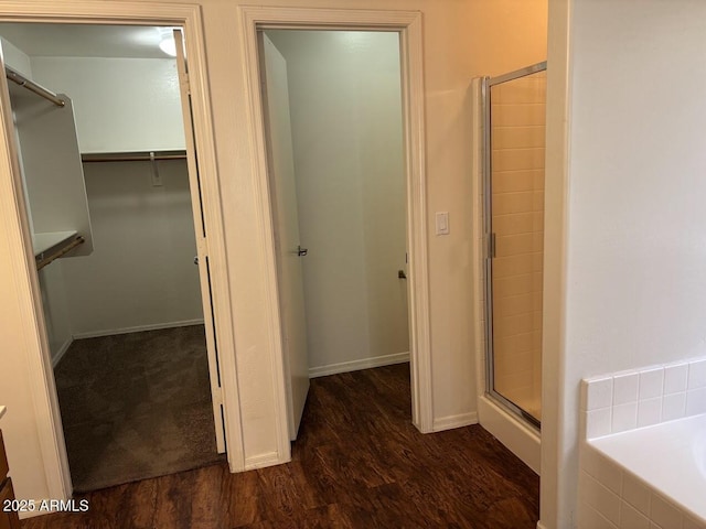 hallway with dark wood-type flooring and baseboards