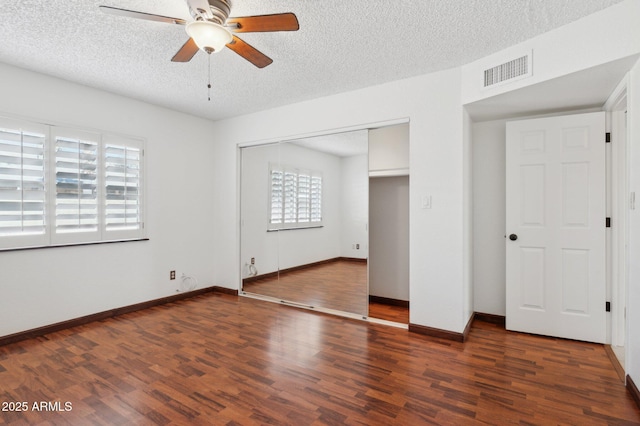 unfurnished bedroom featuring a closet, ceiling fan, and dark hardwood / wood-style floors