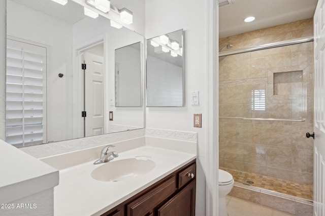 bathroom with toilet, tile patterned floors, walk in shower, and vanity