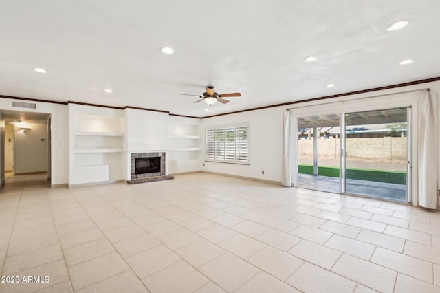 unfurnished living room with ceiling fan, crown molding, a fireplace, built in features, and light tile patterned flooring