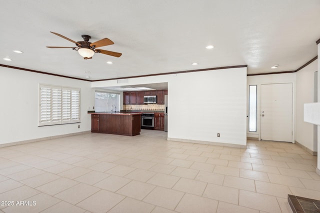 unfurnished living room with light tile patterned floors, ceiling fan, crown molding, and sink