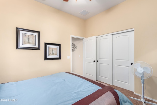 carpeted bedroom with ceiling fan and a closet