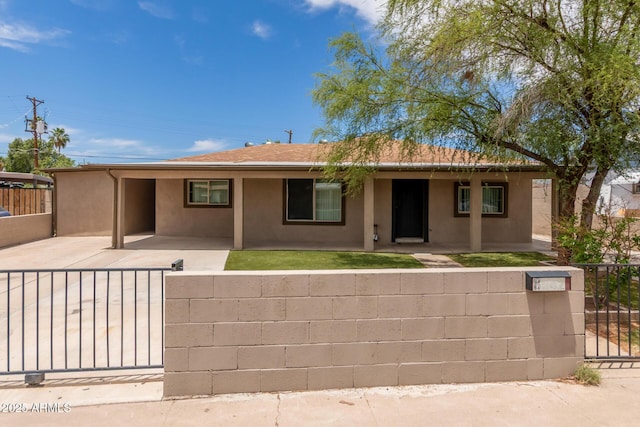 8542 N 30th Dr, Phoenix, AZ 85051 - view of front of home with a fenced front yard, stucco siding, a gate, and a carport
