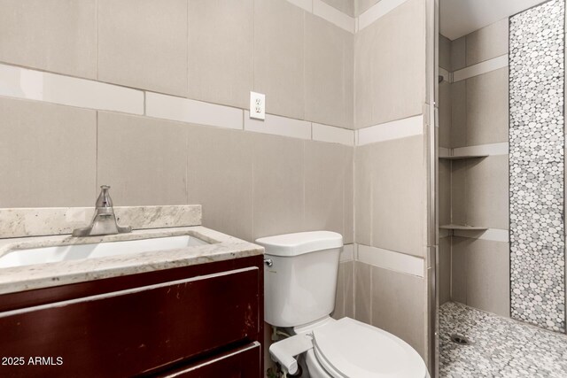 8542 N 30th Dr, Phoenix, AZ 85051 - bathroom with a shower stall, vanity, toilet, and tile walls