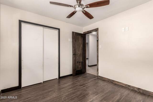 8542 N 30th Dr, Phoenix, AZ 85051 - unfurnished bedroom with wood finished floors, baseboards, a closet, and a ceiling fan