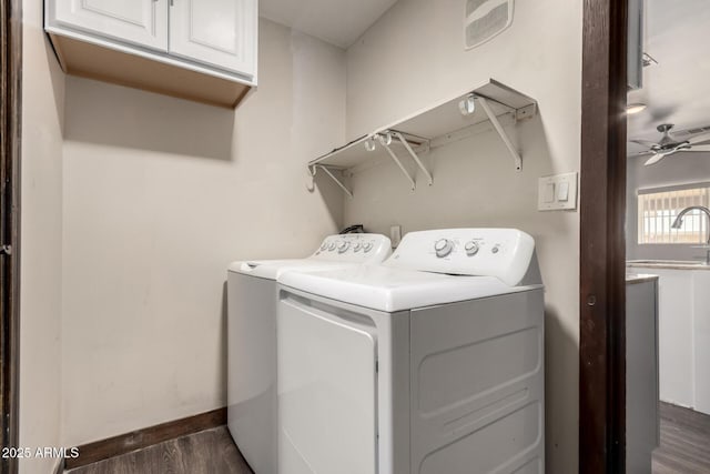 8542 N 30th Dr, Phoenix, AZ 85051 - laundry room featuring cabinet space, washing machine and clothes dryer, dark wood-type flooring, baseboards, and a ceiling fan