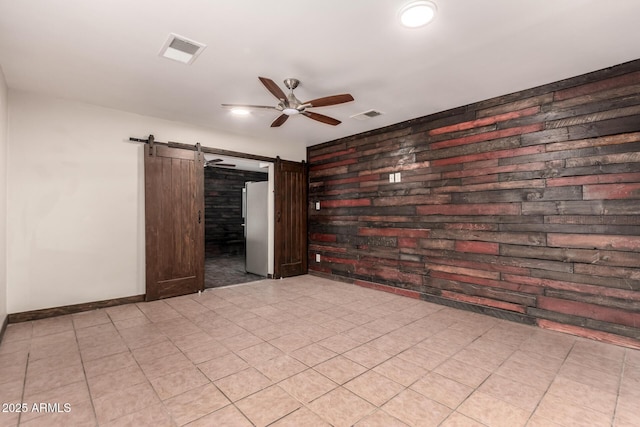 8542 N 30th Dr, Phoenix, AZ 85051 - spare room with a barn door, ceiling fan, and baseboards