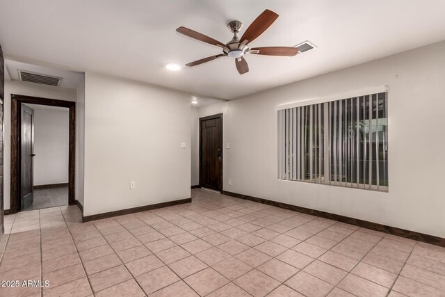 8542 N 30th Dr, Phoenix, AZ 85051 - spare room featuring a ceiling fan, baseboards, and light tile patterned flooring