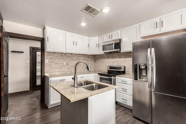 8542 N 30th Dr, Phoenix, AZ 85051 - kitchen featuring stainless steel appliances, a sink, white cabinetry, dark wood-style flooring, and light stone counters