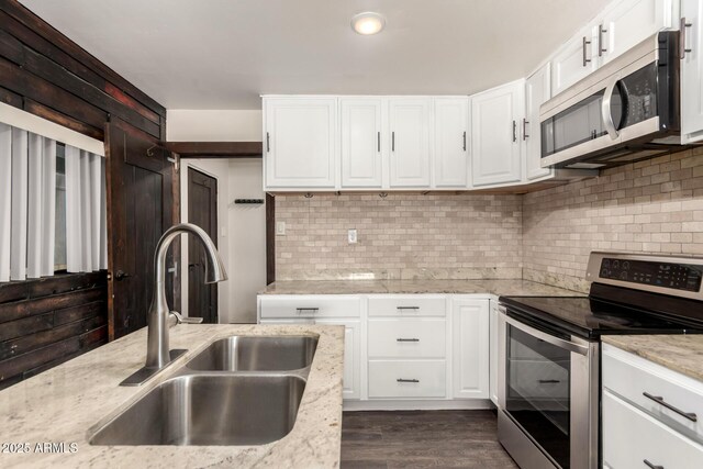8542 N 30th Dr, Phoenix, AZ 85051 - kitchen with stainless steel appliances, a sink, white cabinetry, tasteful backsplash, and recessed lighting