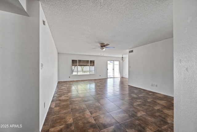 tiled spare room featuring a textured ceiling and ceiling fan