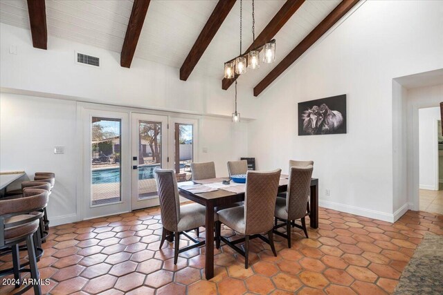 dining area featuring beam ceiling, high vaulted ceiling, and tile patterned flooring