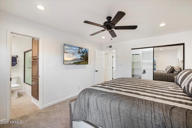 carpeted bedroom with ceiling fan and connected bathroom