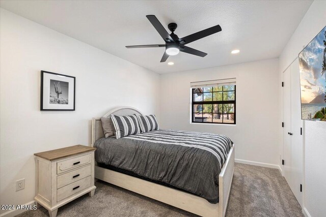 carpeted bedroom featuring ceiling fan