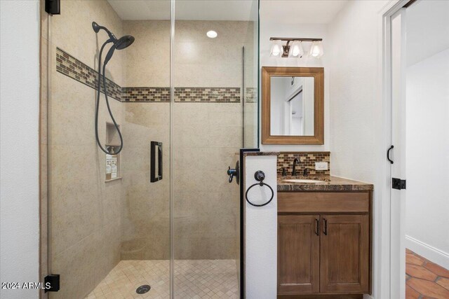 bathroom with a shower with door and vanity