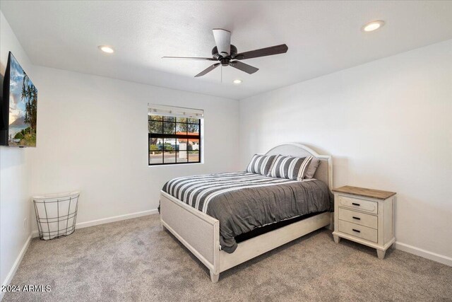 carpeted bedroom with ceiling fan