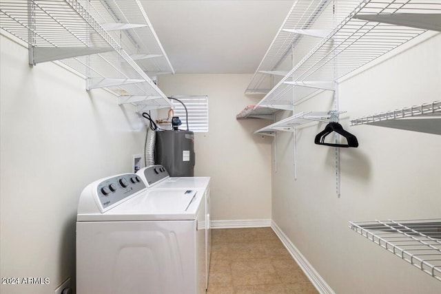 laundry area with washing machine and clothes dryer and water heater