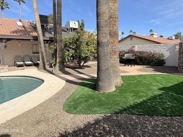 exterior space with an outdoor living space, a patio, and a fenced in pool